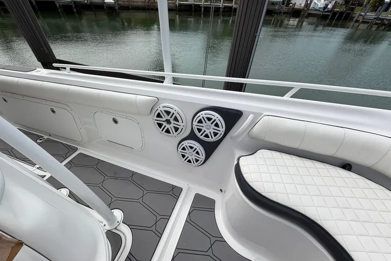 Slide: The Image of 2020 Glasstream 360 SCX boat interior with speakers and cushioned seating. - 8