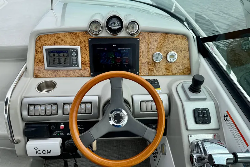 Slide: The Image of Dashboard of a 2008 Formula 350 Sun Sport boat with wood accents and modern controls. - 11