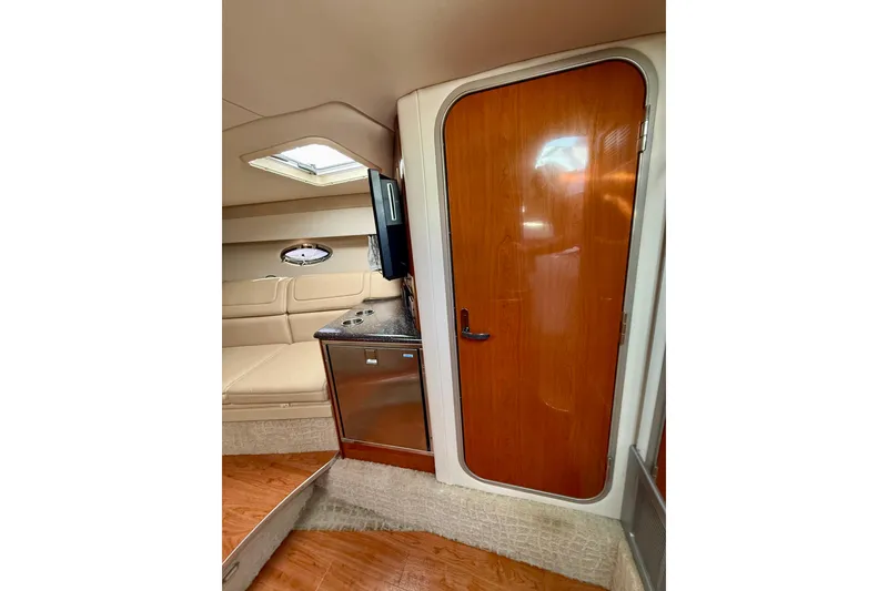 Slide: The Image of Interior of 2008 Formula 350 Sun Sport boat with wood door and seating area. - 15