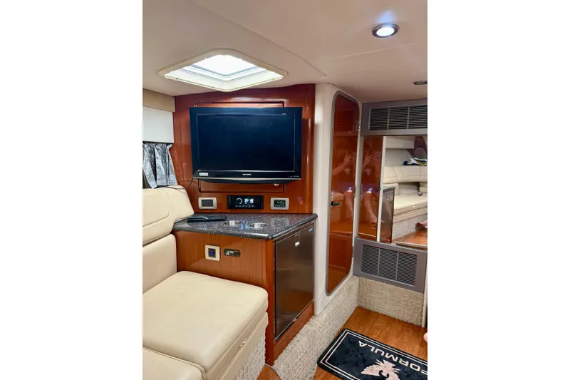 Slide: The Image of Interior of 2008 Formula 350 Sun Sport boat with TV, seating, and wood accents. - 17