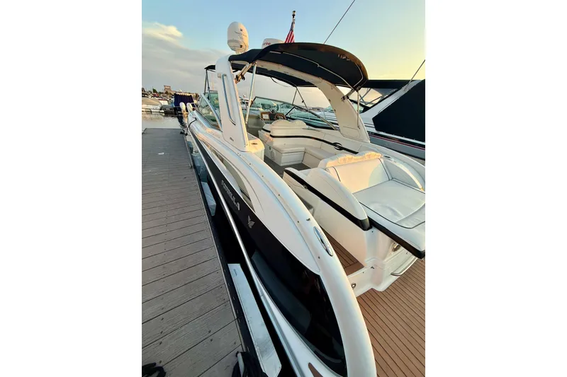 Slide: The Image of 2008 Formula 350 Sun Sport boat docked, featuring sleek design and spacious seating. - 4