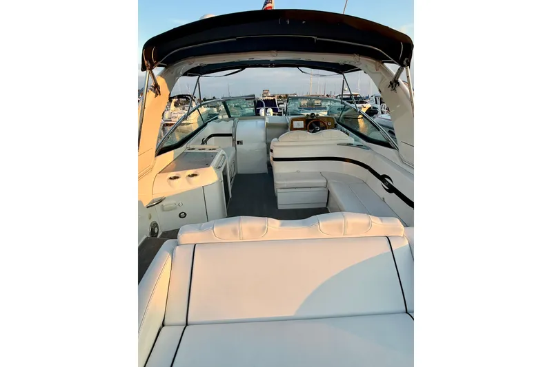 Slide: The Image of 2008 Formula 350 Sun Sport boat interior with white seating and helm, docked at marina. - 7