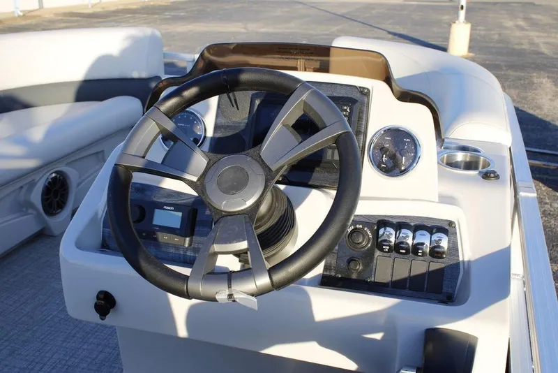 Slide: The Image of Steering console of 2026 Avalon VLS QUAD LOUNGER 21 boat with modern controls. - 17