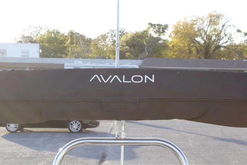 Slide: The Image of 2026 Avalon VLS QUAD LOUNGER 21 boat cover with logo in outdoor setting. - 26