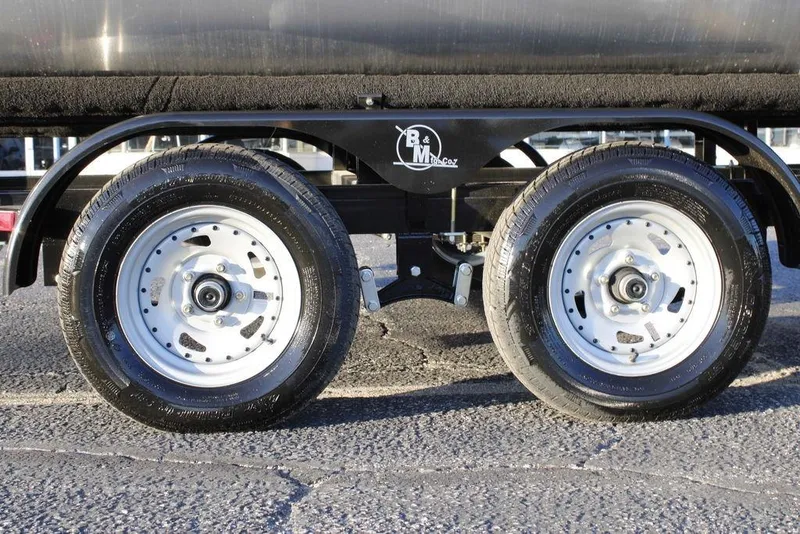 Slide: The Image of Dual wheels of 2026 Avalon VLS QUAD LOUNGER 21 trailer on asphalt surface. - 3