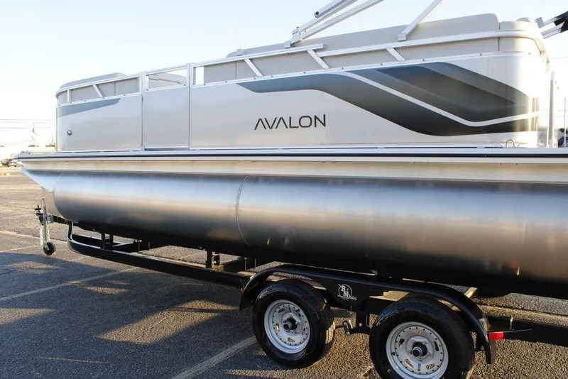 Slide: The Image of 2026 Avalon VLS QUAD LOUNGER 21 pontoon boat on trailer, side view. - 36