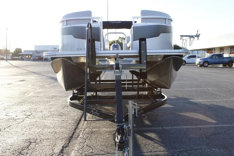 Slide: The Image of 2026 Avalon VLS QUAD LOUNGER 21 pontoon boat on trailer in parking lot. - 4