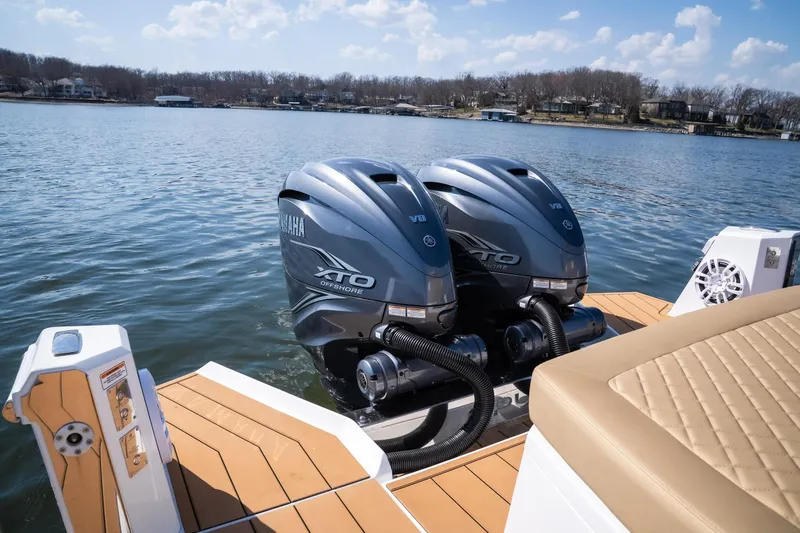 Slide: The Image of Twin Yamaha XTO Offshore engines on Opus OPUS 12 boat, 2024 model, on a serene lake. - 15