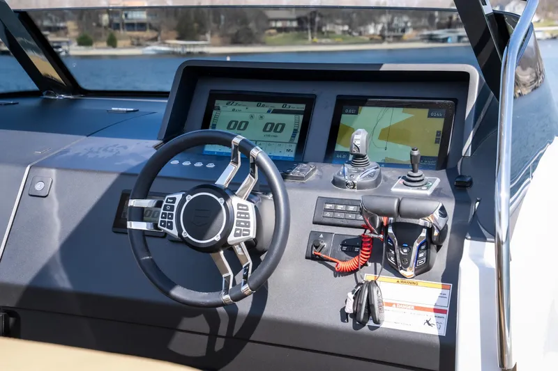 Slide: The Image of 2024 Opus OPUS 12 boat dashboard with steering wheel and navigation screens. - 18