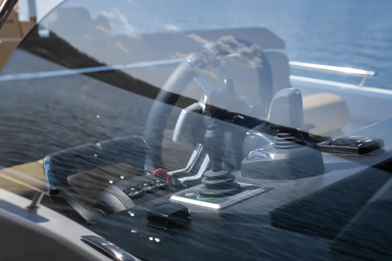 Slide: The Image of Cockpit of 2024 Opus OPUS 12 yacht with steering controls and water view. - 20