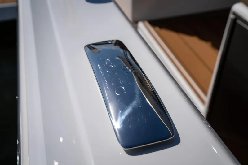 Slide: The Image of Chrome detail on 2024 Opus OPUS 12 boat, reflecting sunlight. - 21