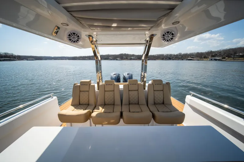 Slide: The Image of Luxurious 2024 Opus OPUS 12 boat interior with plush seating overlooking serene lake. - 23