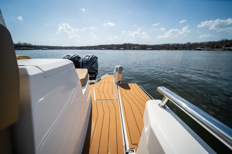 Slide: The Image of 2024 Opus OPUS 12 boat with dual engines on a serene lake. - 25