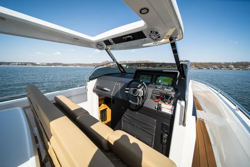 Slide: The Image of Luxurious 2024 Opus OPUS 12 boat interior with modern dashboard on a serene lake. - 29