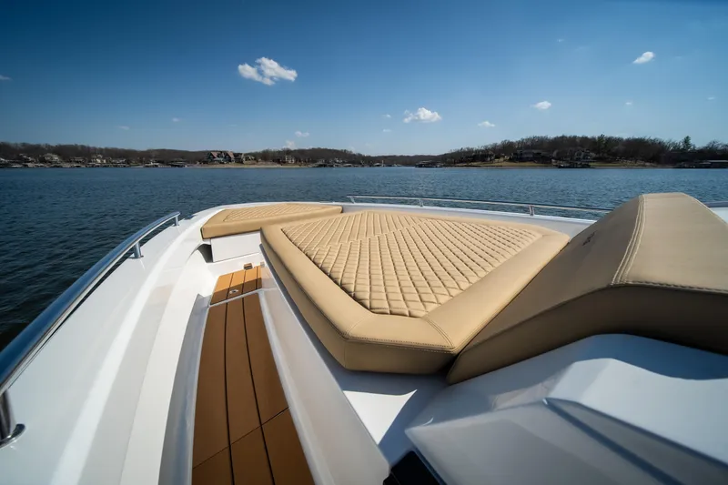 Slide: The Image of Luxurious 2024 Opus OPUS 12 boat with cushioned deck on a serene lake. - 32