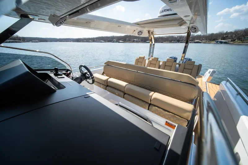 Slide: The Image of Luxurious 2024 Opus OPUS 12 yacht interior with plush seating and modern helm, on serene water. - 33