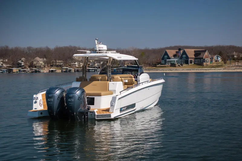 Slide: The Image of 2024 Opus OPUS 12 boat on a serene lake with waterfront homes in the background. - 5