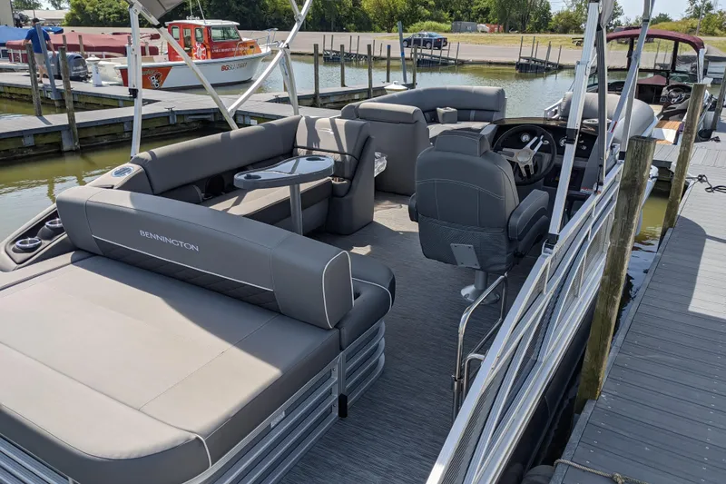Slide: The Image of 2020 Bennington SXP 23 SSBXP pontoon boat with spacious seating at a dock. - 10