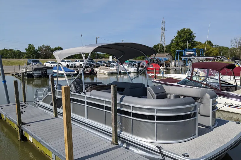 Slide: The Image of 2020 Bennington SXP 23 SSBXP pontoon boat docked at a marina. - 4