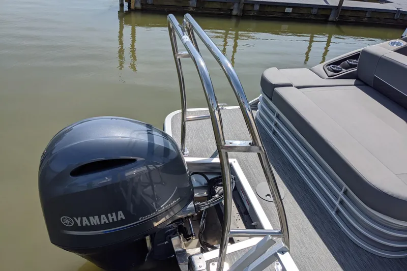 Slide: The Image of 2020 Bennington SXP 23 SSBXP pontoon boat with Yamaha outboard motor, docked on calm water. - 6