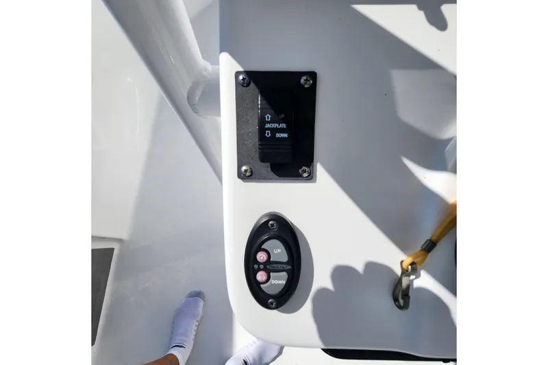 Slide: The Image of 2023 Sea Pro 248 Bay boat control panel with jack plate and trim switches. - 18