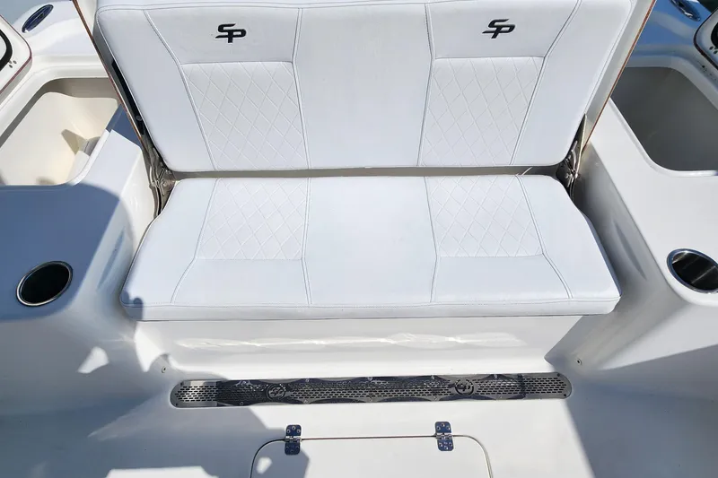 Slide: The Image of 2023 Sea Pro 248 Bay boat seating with white upholstery and cup holders. - 20