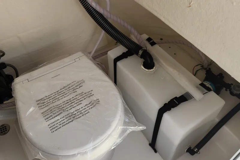 Slide: The Image of 2023 Sea Pro 248 Bay boat toilet and plumbing system in storage compartment. - 22