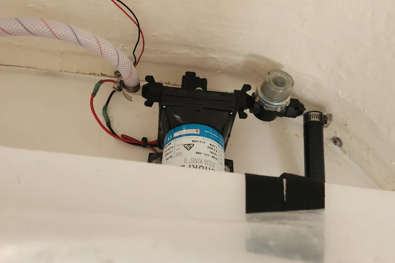 Slide: The Image of 2023 Sea Pro 248 Bay boat pump system with wiring and hoses. - 24