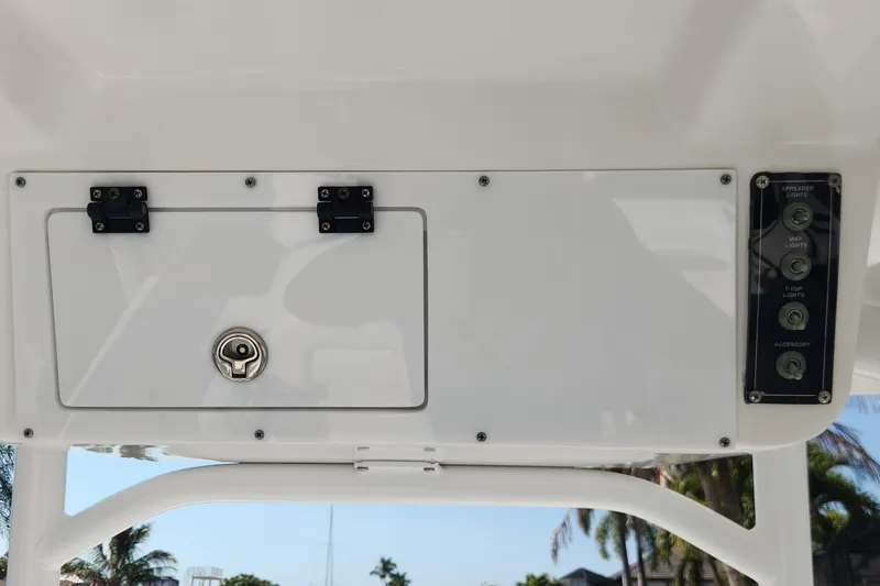 Slide: The Image of 2023 Sea Pro 248 Bay boat console with control panel and storage compartment. - 27