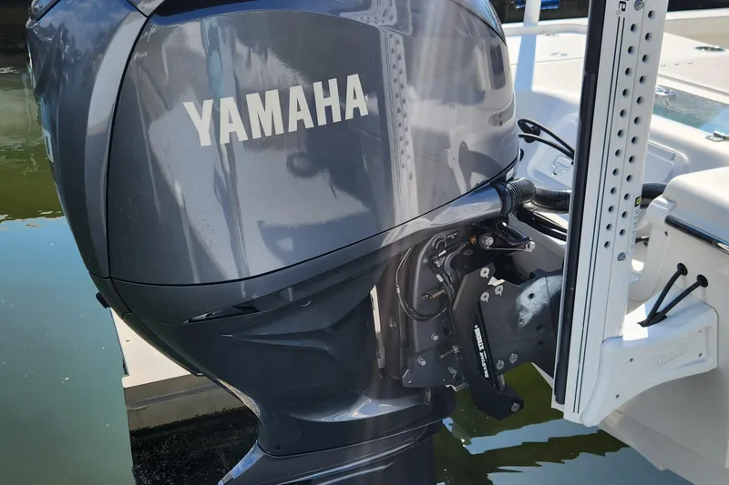 Slide: The Image of 2023 Sea Pro 248 Bay with Yamaha outboard motor, docked on calm water. - 36