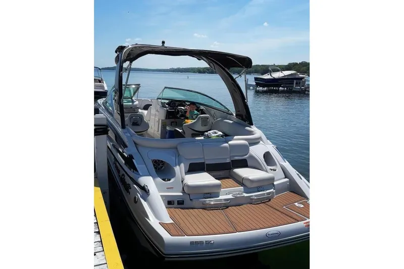 Slide: The Image of 2014 Crownline 255 SS boat docked on a sunny lake. - 2