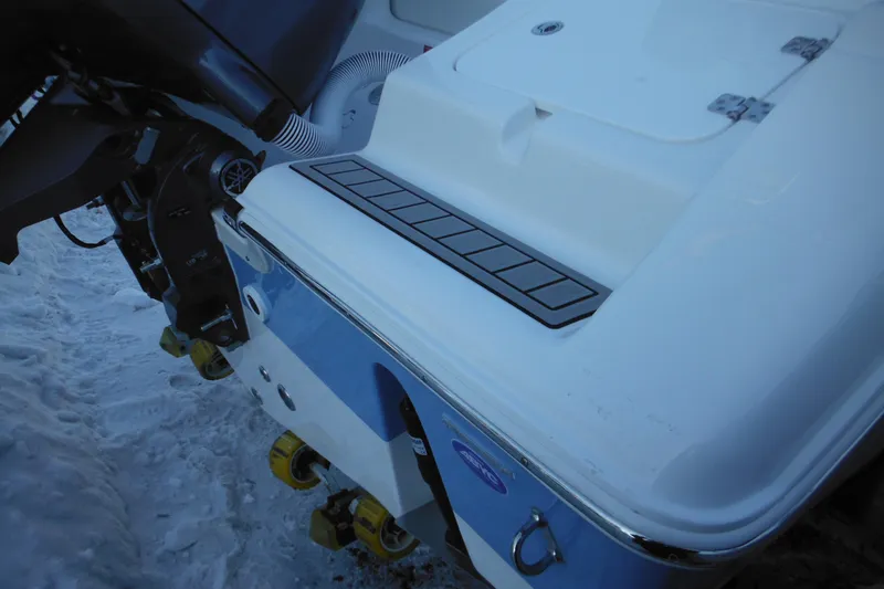 Slide: The Image of 2026 Tidewater 220 LXF boat stern with motor and snow background. - 12