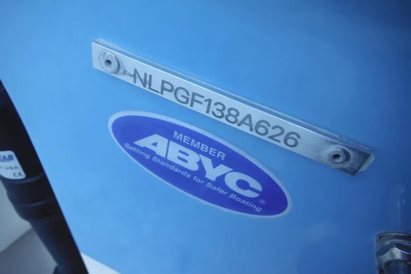 Slide: The Image of 2026 Tidewater 220 LXF boat with ABYC membership plate and serial number. - 13