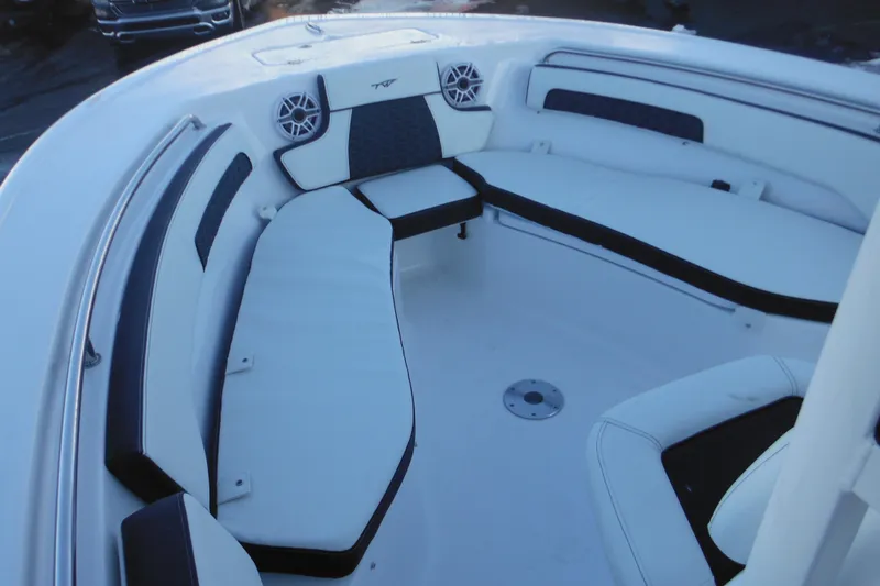 Slide: The Image of 2026 Tidewater 220 LXF boat interior with white cushioned seating and speakers. - 16