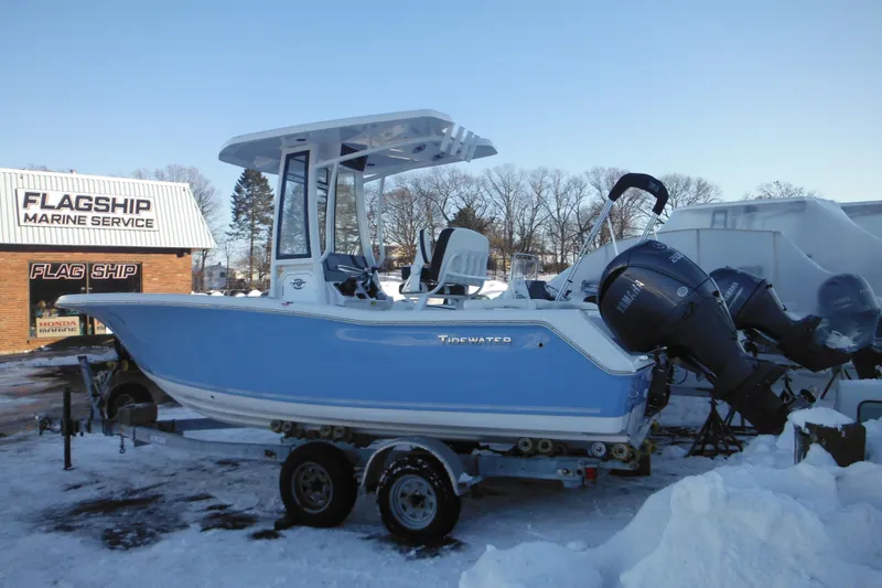 Slide: The Image of 2026 Tidewater 220 LXF boat on trailer at Flagship Marine Service in winter. - 2