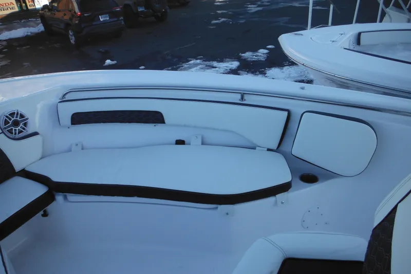 Slide: The Image of 2026 Tidewater 220 LXF boat interior with white seating and speaker. - 20