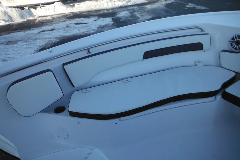Slide: The Image of 2026 Tidewater 220 LXF boat interior with white cushioned seating and speaker. - 21