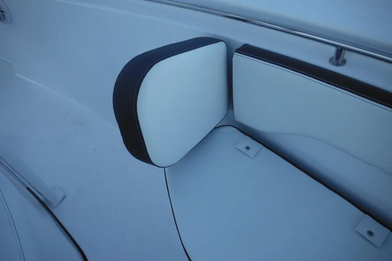 Slide: The Image of 2026 Tidewater 220 LXF boat interior with white cushioned seating and black trim. - 23