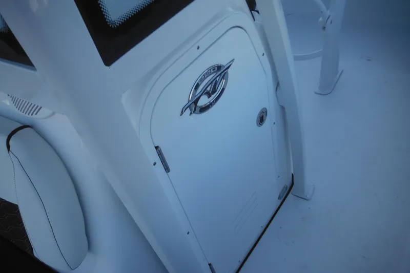 Slide: The Image of 2026 Tidewater 220 LXF boat interior with sleek white design and logo detail. - 24