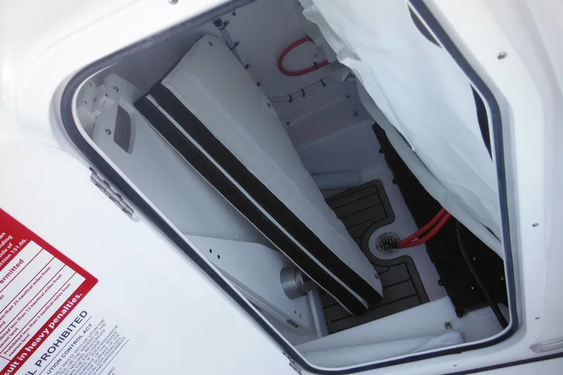 Slide: The Image of 2026 Tidewater 220 LXF boat storage compartment with red wiring and drainage system. - 27