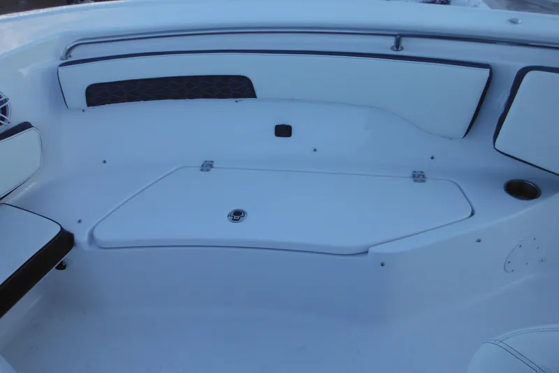Slide: The Image of 2026 Tidewater 220 LXF boat interior with white seating and storage compartment. - 28