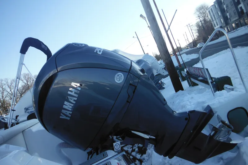 Slide: The Image of Tidewater 220 LXF 2026 boat with Yamaha outboard engine in snowy setting. - 3