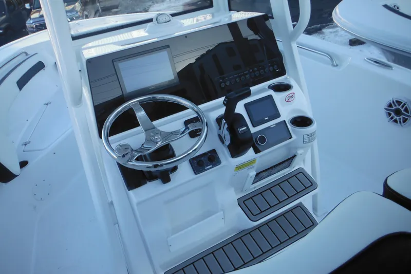 Slide: The Image of 2026 Tidewater 220 LXF boat console with steering wheel and modern controls. - 33