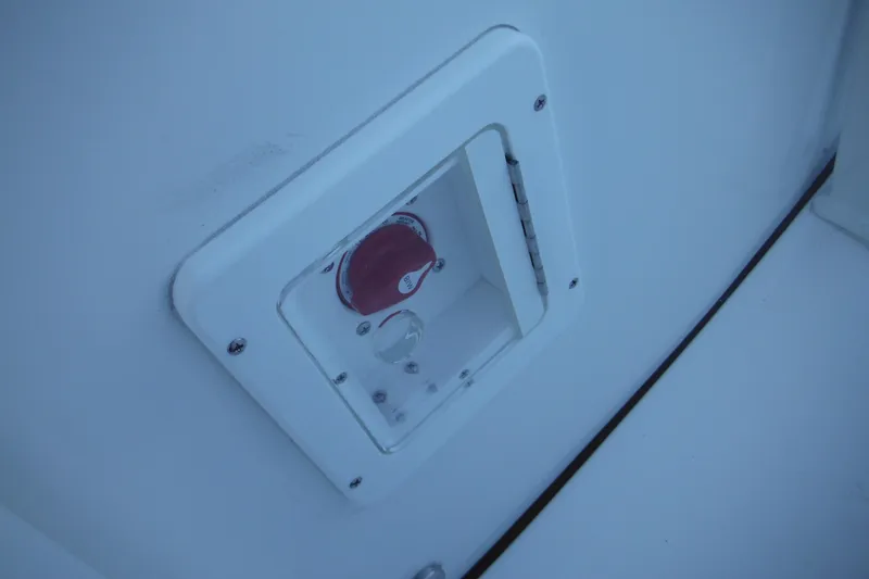 Slide: The Image of Close-up of a 2026 Tidewater 220 LXF boat's control panel with a red switch. - 37