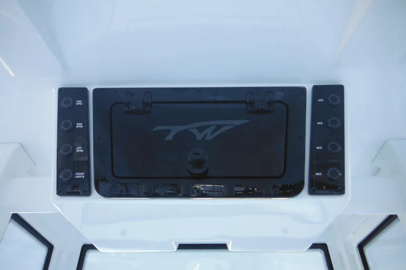 Slide: The Image of 2026 Tidewater 220 LXF boat dashboard with control panel and storage compartment. - 40