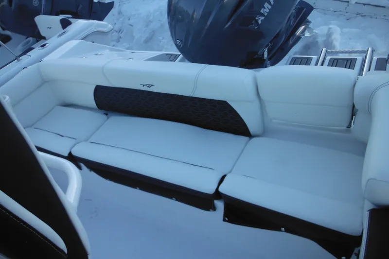 Slide: The Image of 2026 Tidewater 220 LXF boat interior with white cushioned seating and Yamaha engine. - 42