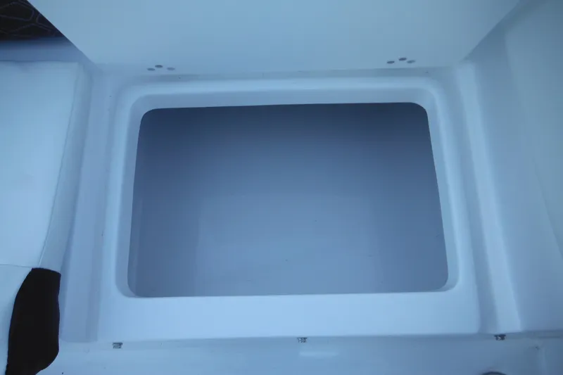 Slide: The Image of Storage compartment of 2026 Tidewater 220 LXF boat, open and empty. - 45