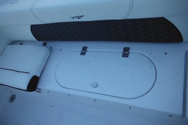 Slide: The Image of 2026 Tidewater 220 LXF boat interior with storage compartment and cushion. - 47
