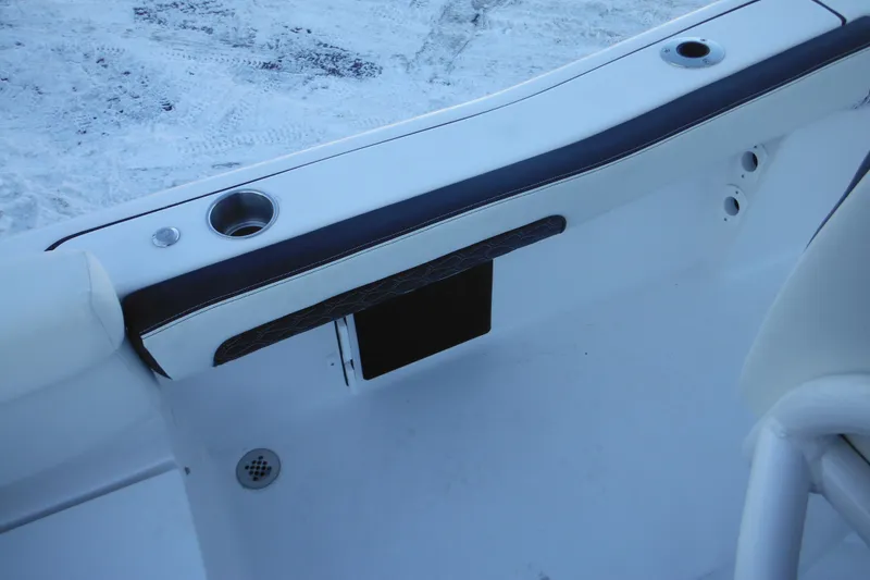 Slide: The Image of 2026 Tidewater 220 LXF boat interior with cup holders and seating detail. - 53