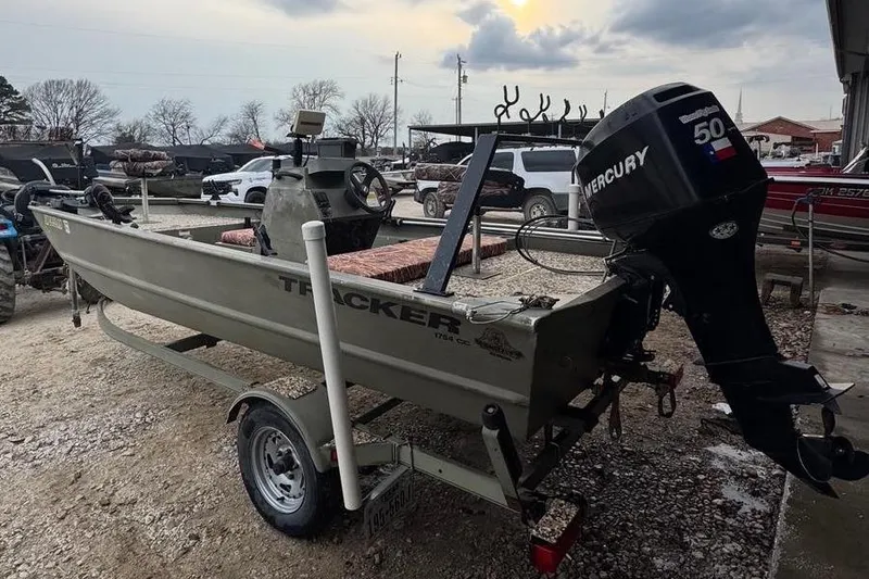 Slide: The Image of 2007 Tracker Grizzly 1754 CC All-Welded boat with Mercury engine under cloudy sky. - 6